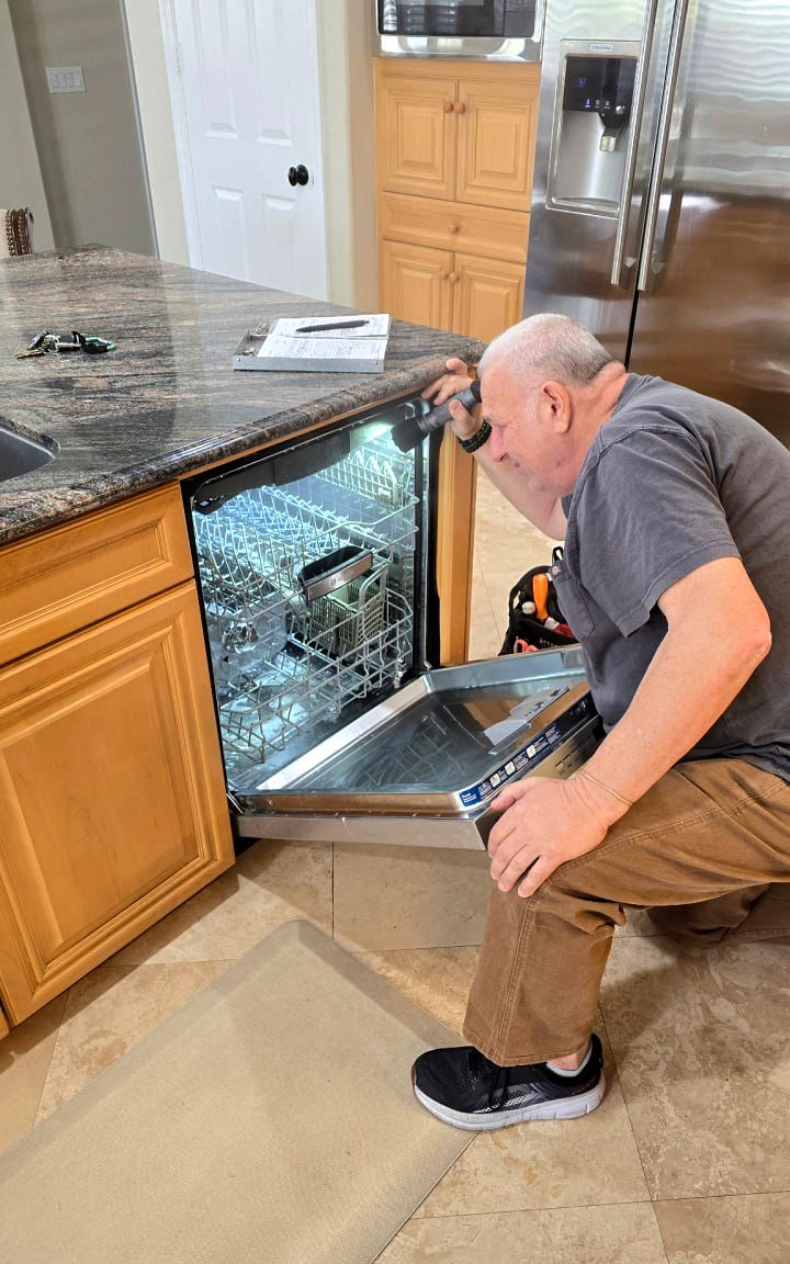 Larry Bezman repairing a dishwasher